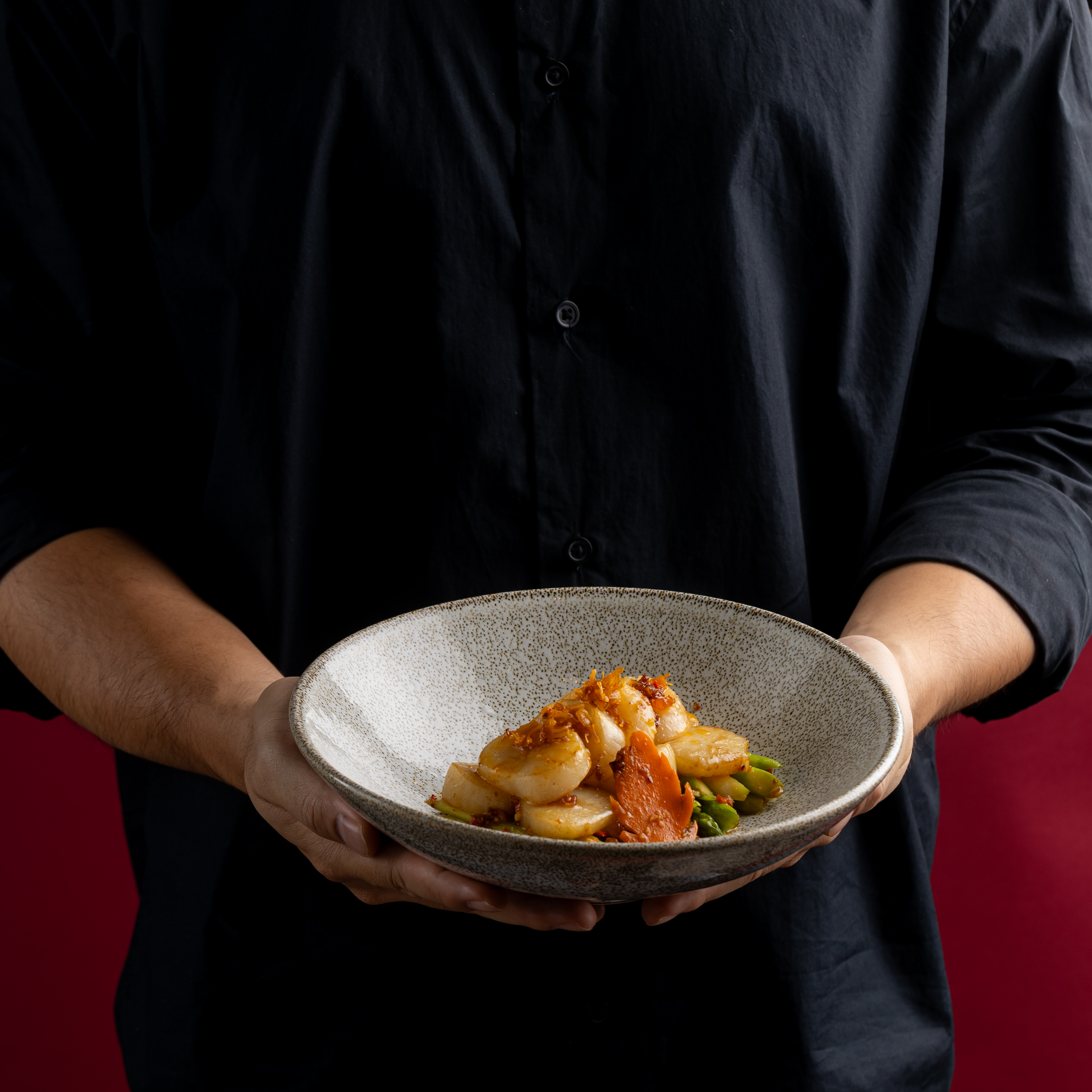 a person holding a plate of food