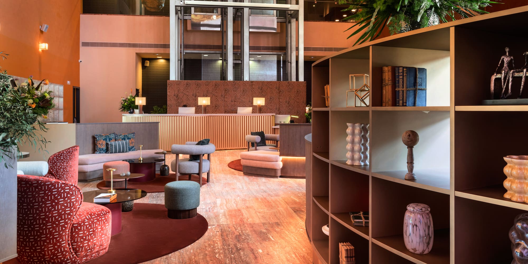 a room with a large round table and shelves