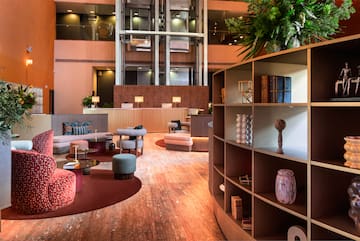 a room with a large round table and shelves