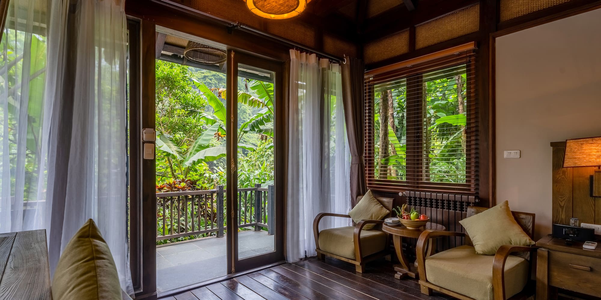a room with a glass door and a table and chairs