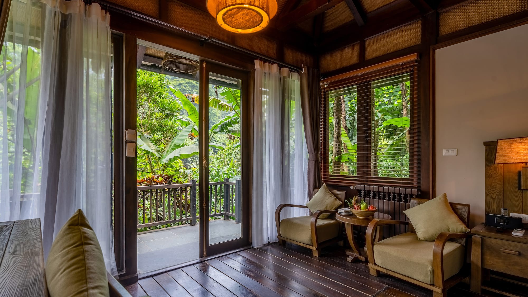 a room with a glass door and a table and chairs