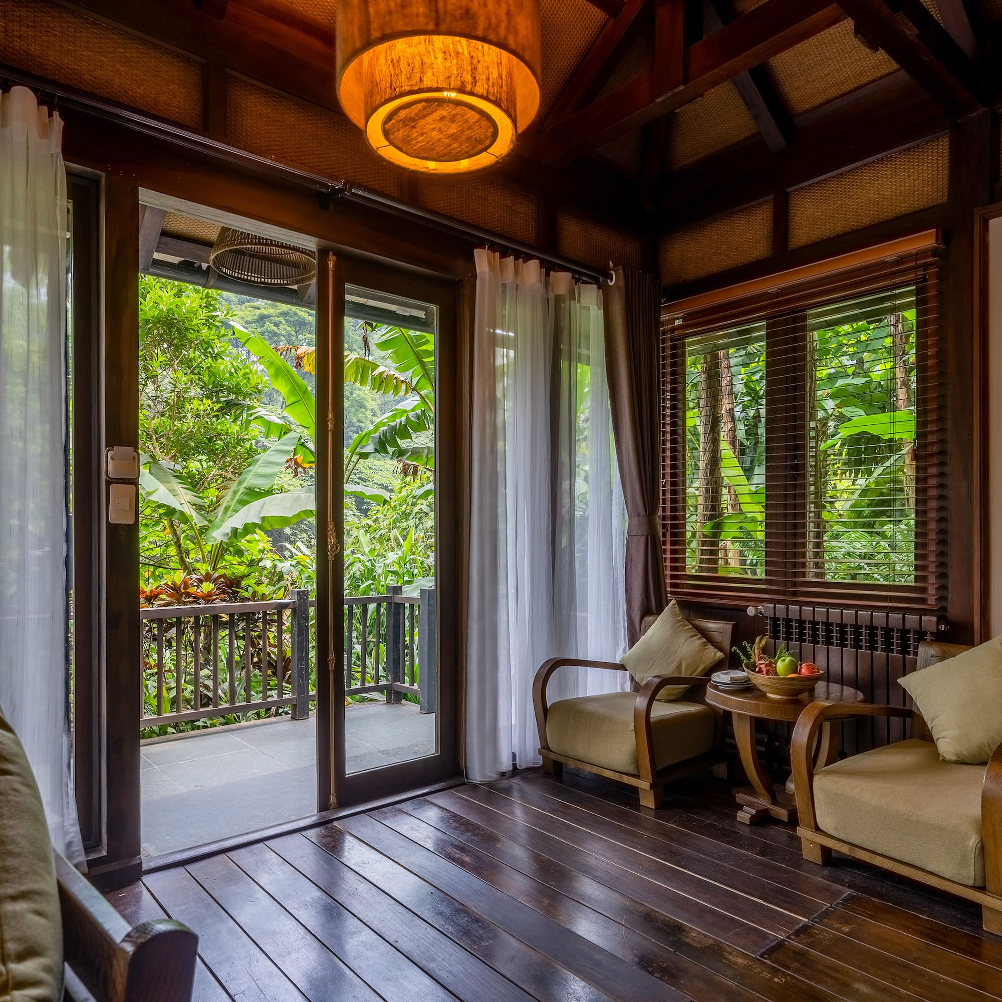 a room with a glass door and a table and chairs