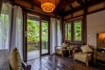 a room with a glass door and a table and chairs