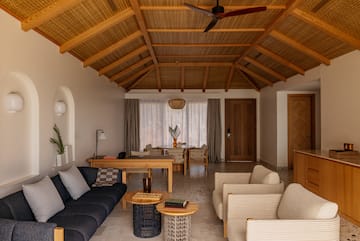 a living room with a couch and chairs