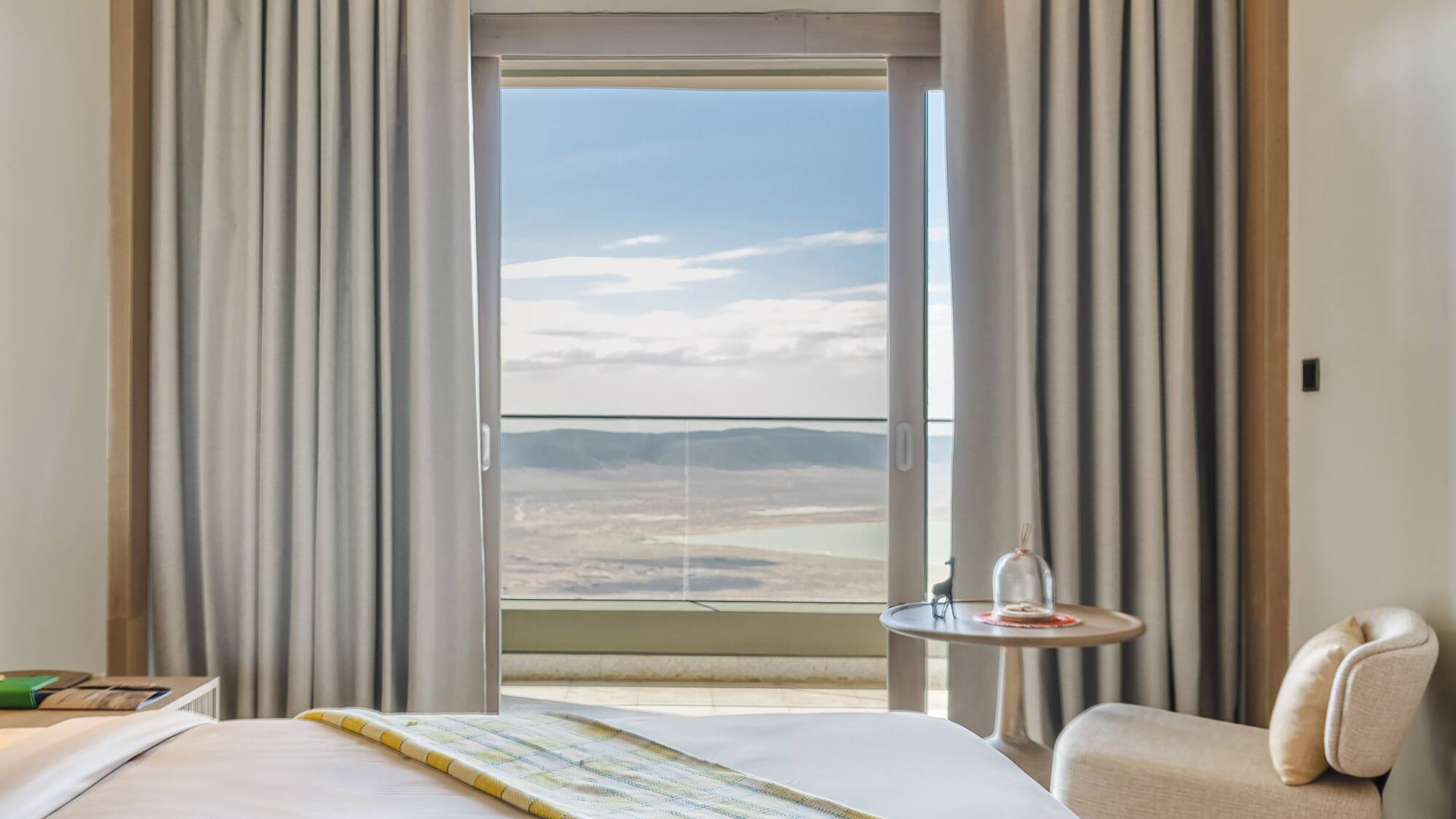 a room with two beds and a table with chairs and a window