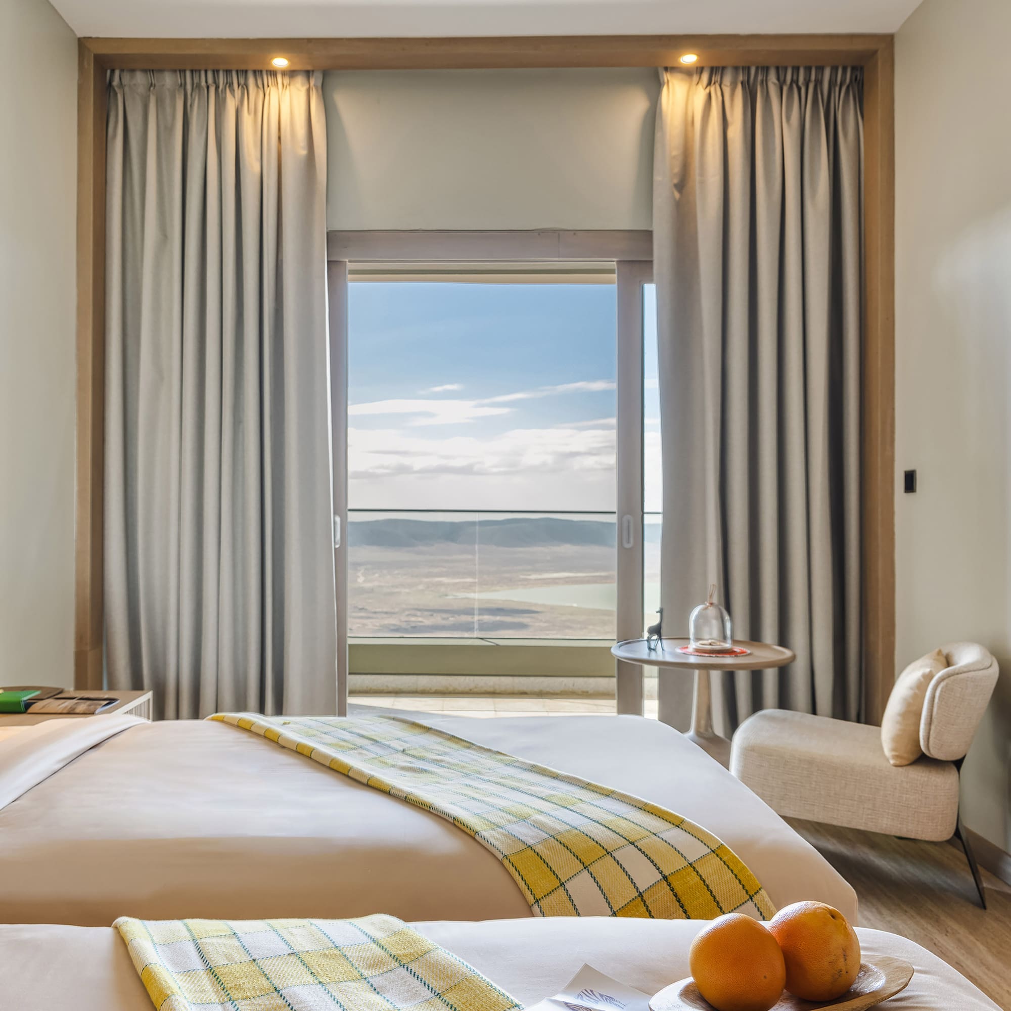 a room with two beds and a table with chairs and a window