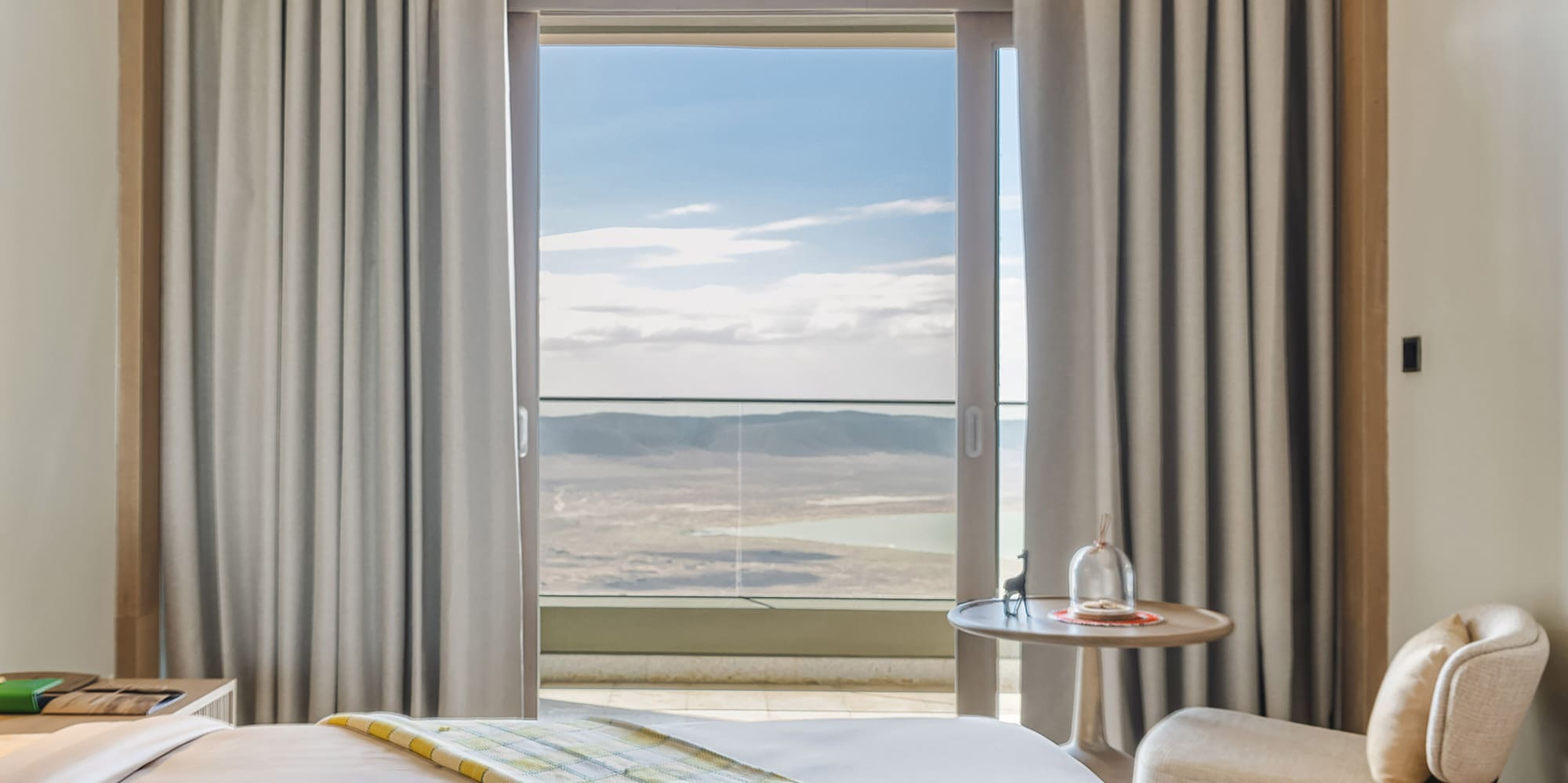 a room with two beds and a table with chairs and a window