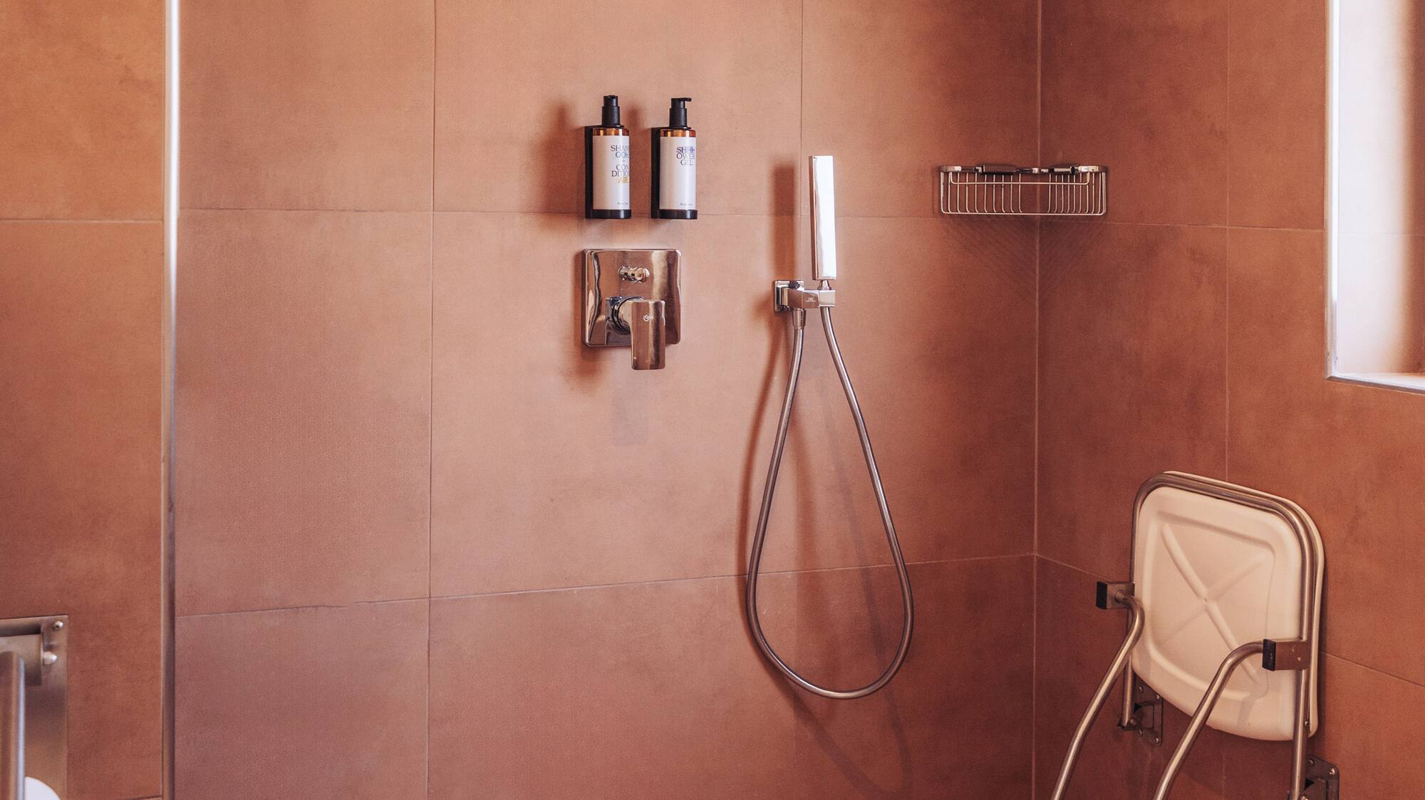 a shower with a shower head and a shower head