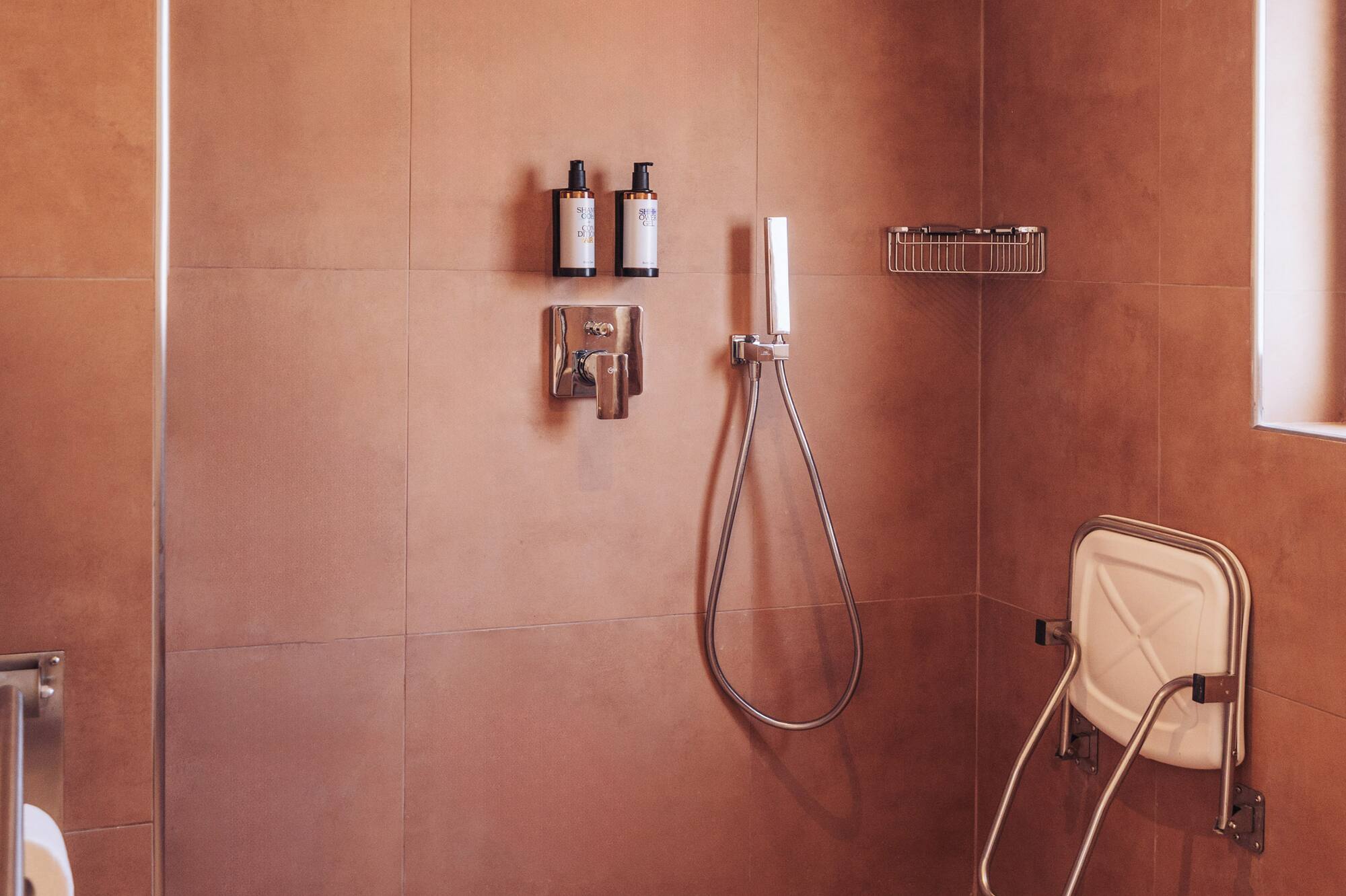 a shower with a shower head and a shower head