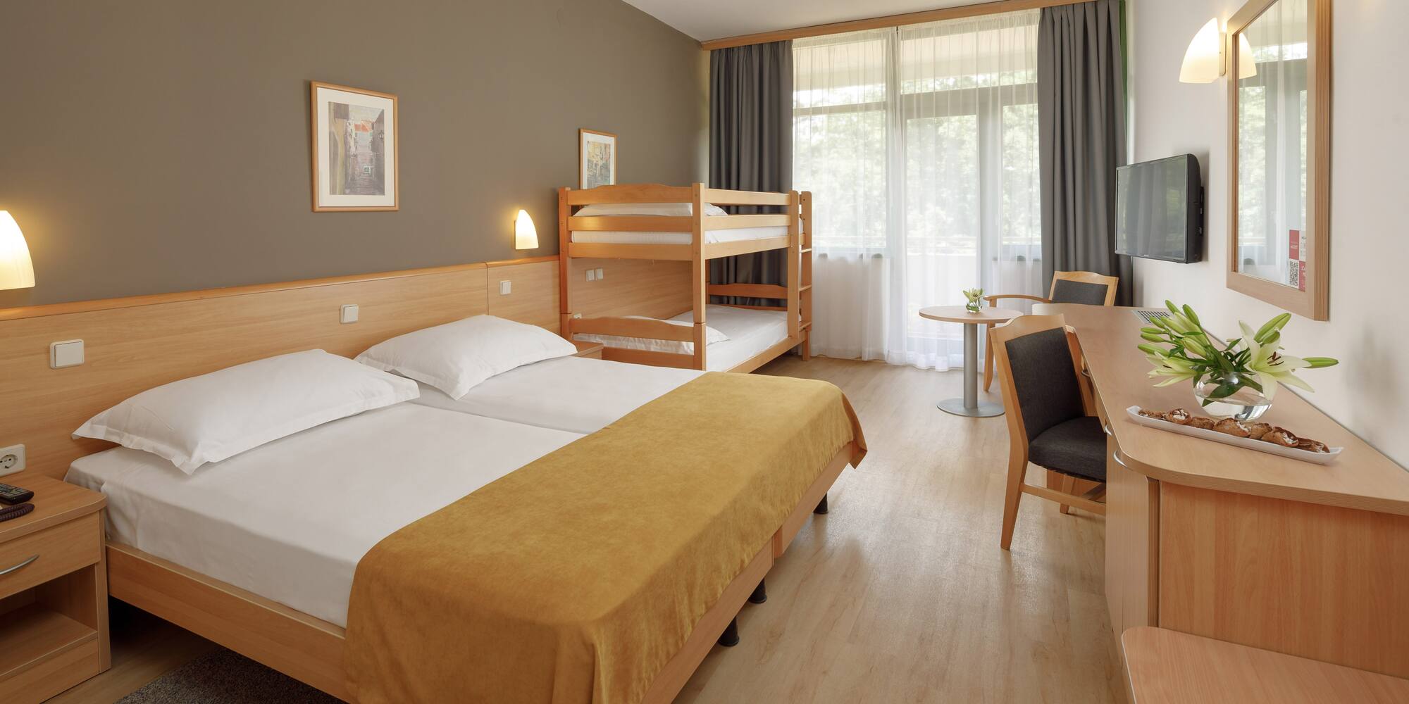 a room with bunk beds and a desk