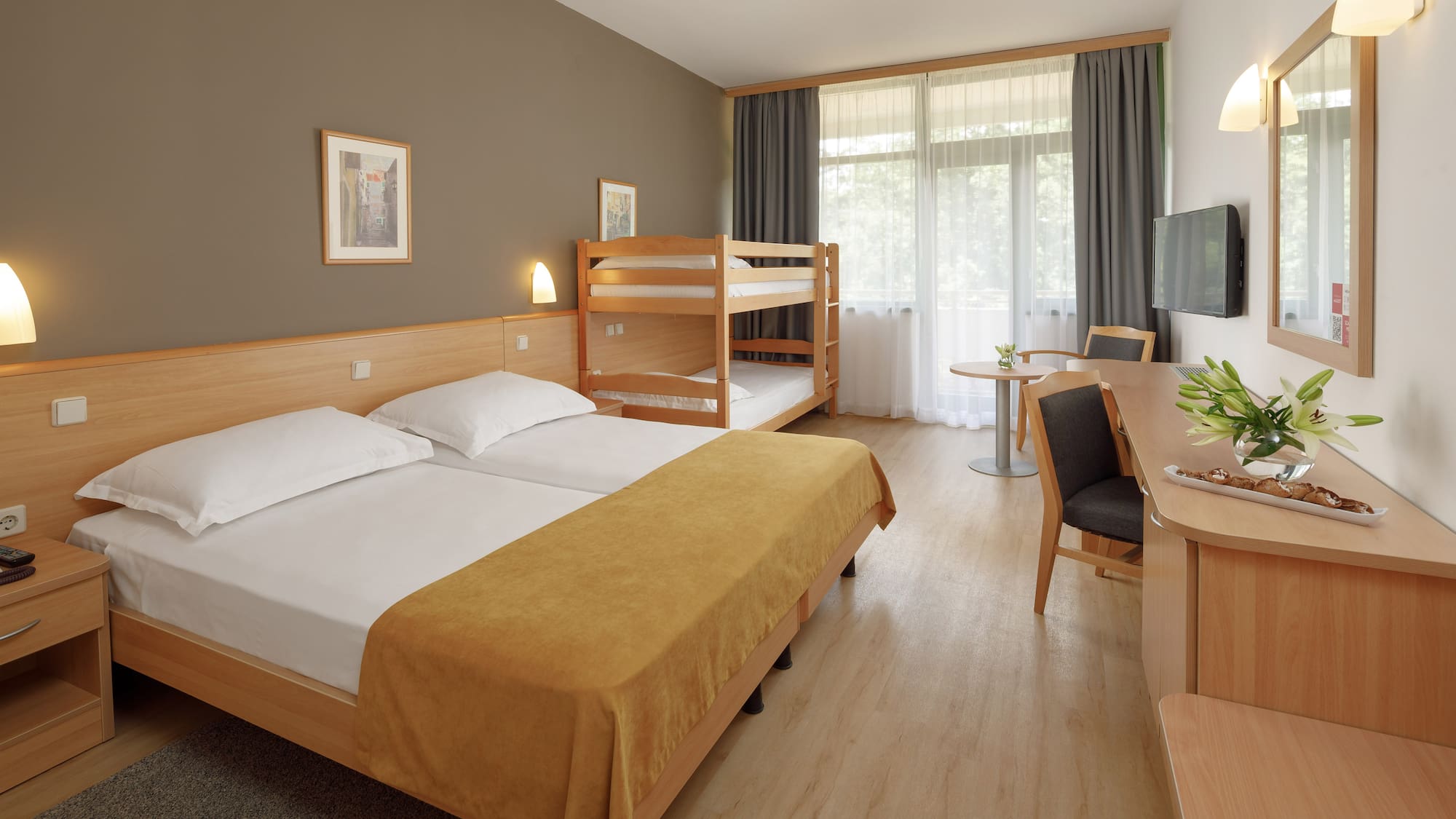 a room with bunk beds and a desk
