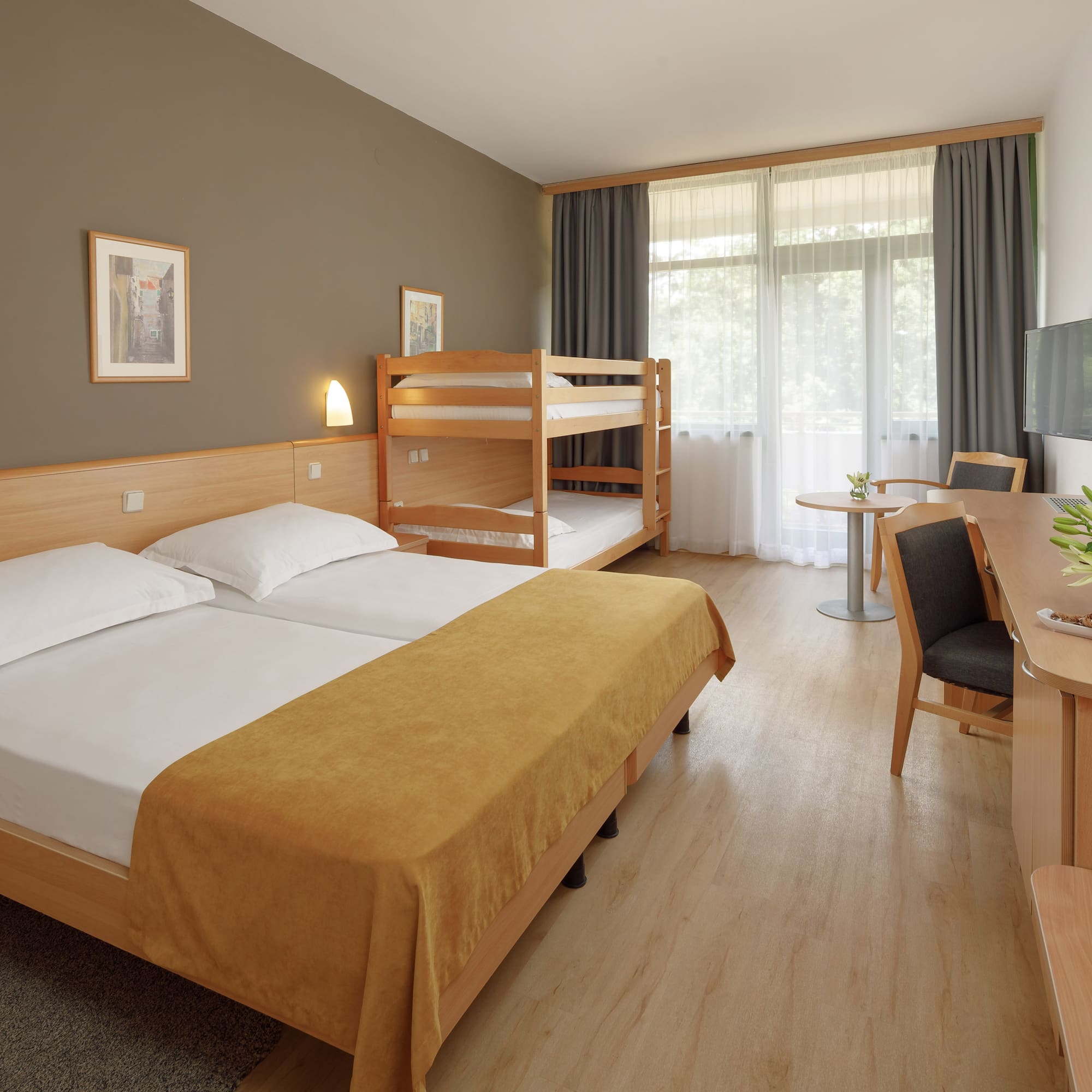 a room with bunk beds and a desk