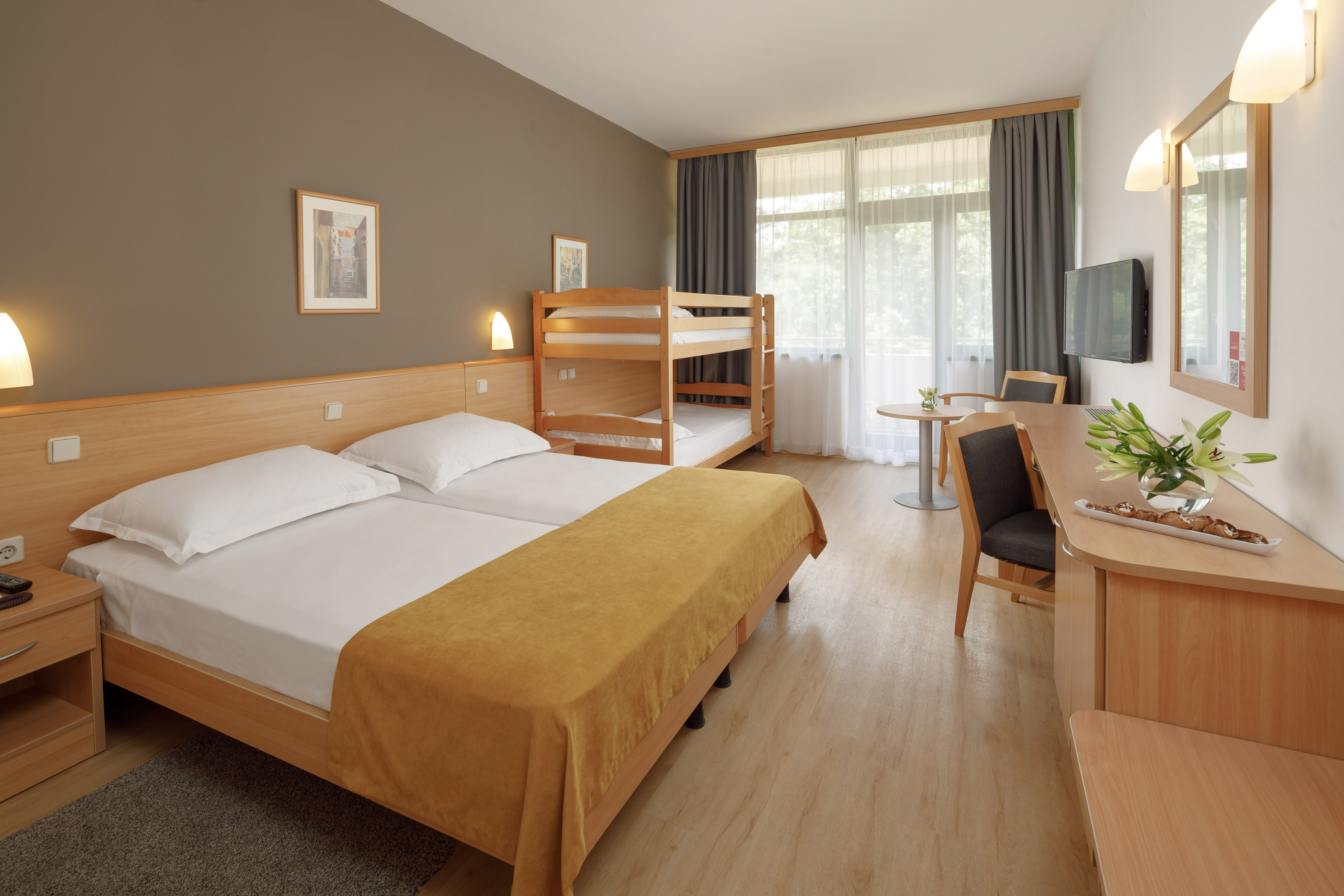 a room with bunk beds and a desk