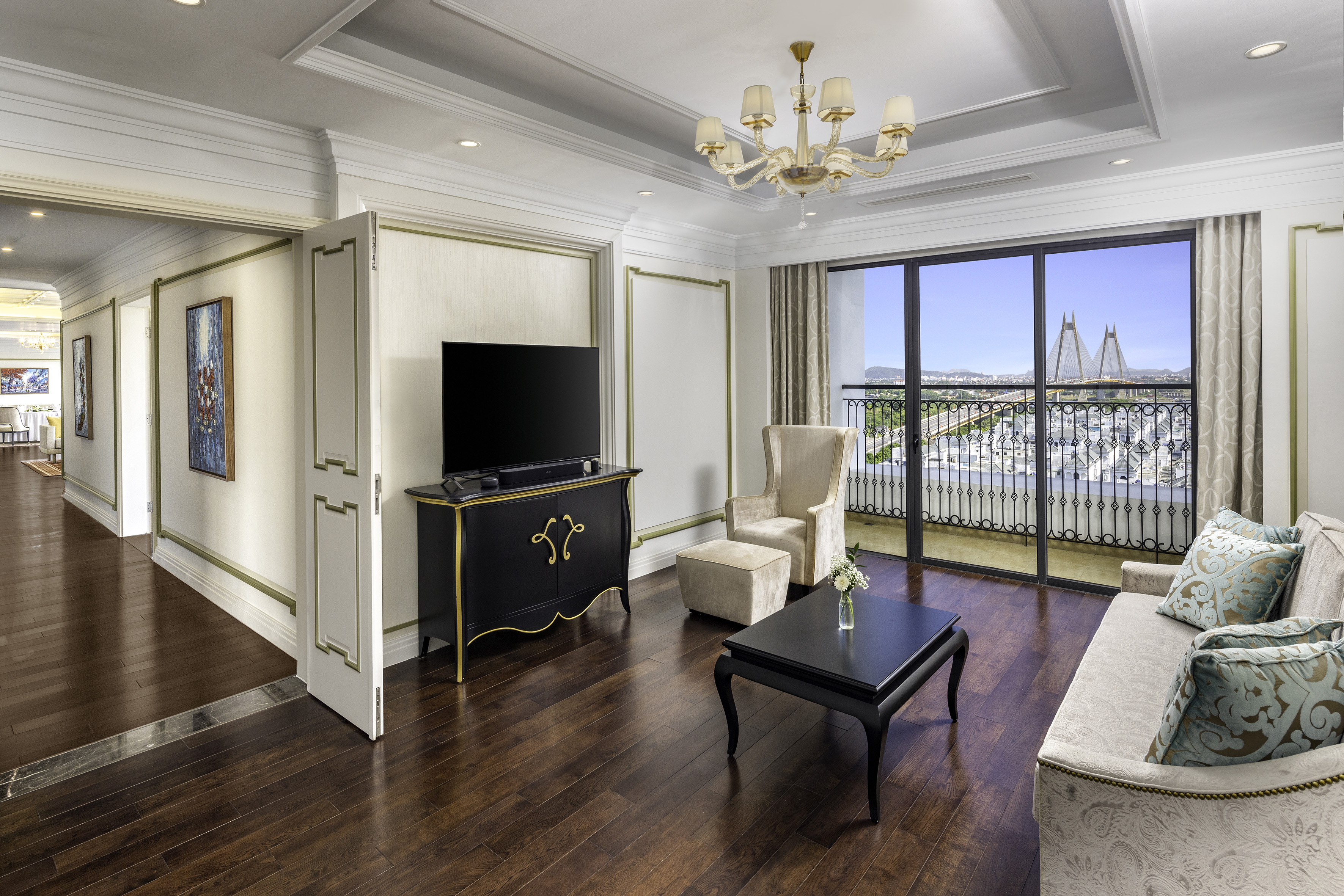 Elegant living room suite, balcony city view with bridge, sofa, hardwood floor.