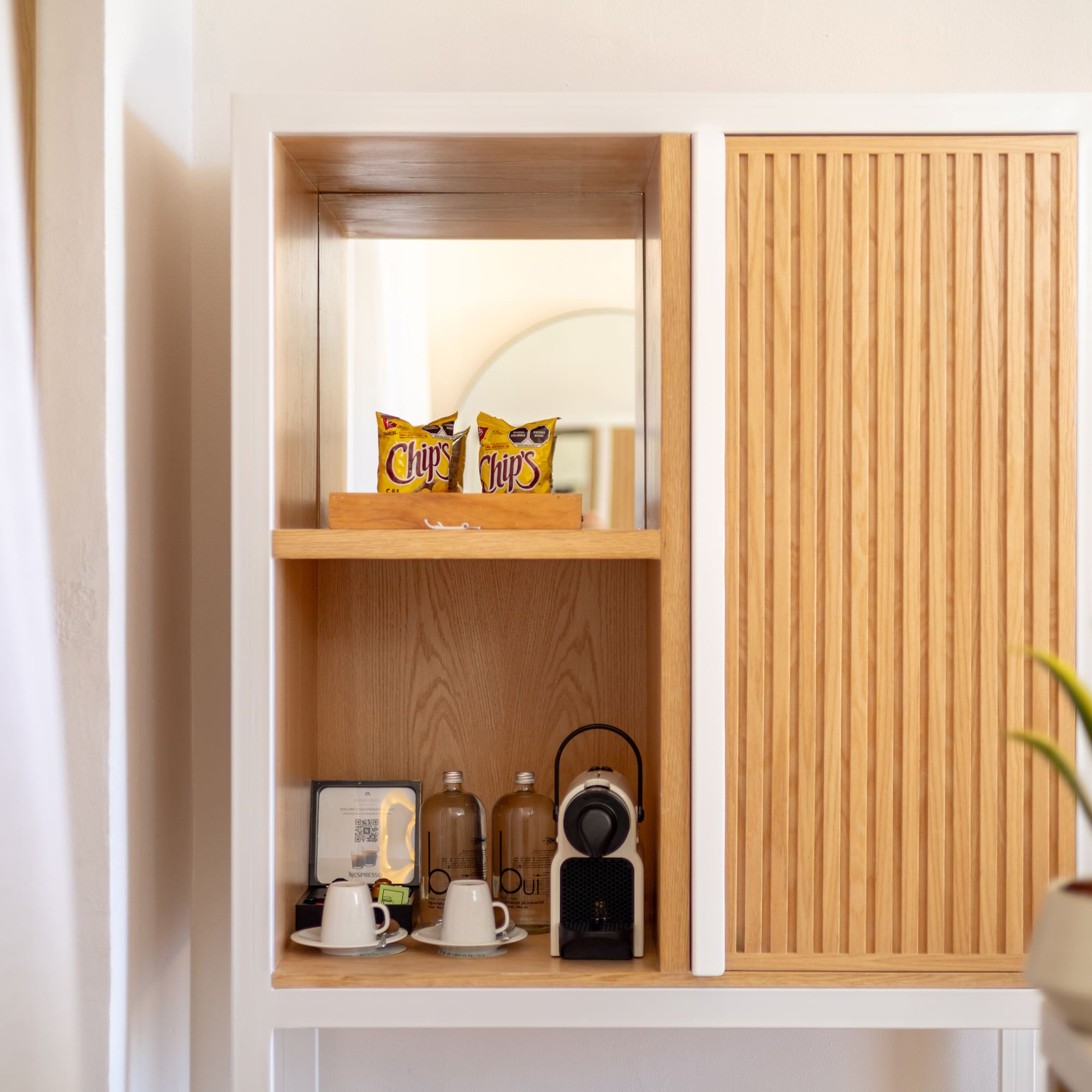 a shelf with a white cabinet and a white wall