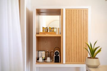 a shelf with a white cabinet and a white wall