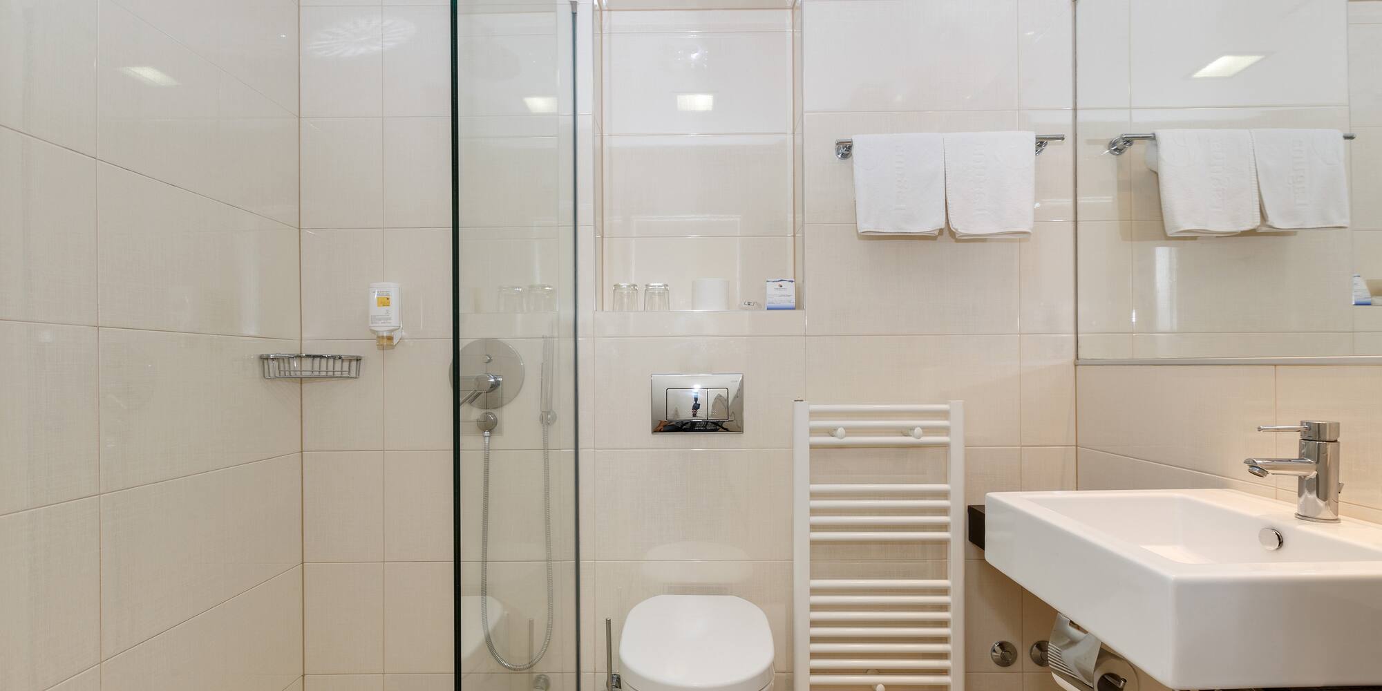 a bathroom with a glass shower door