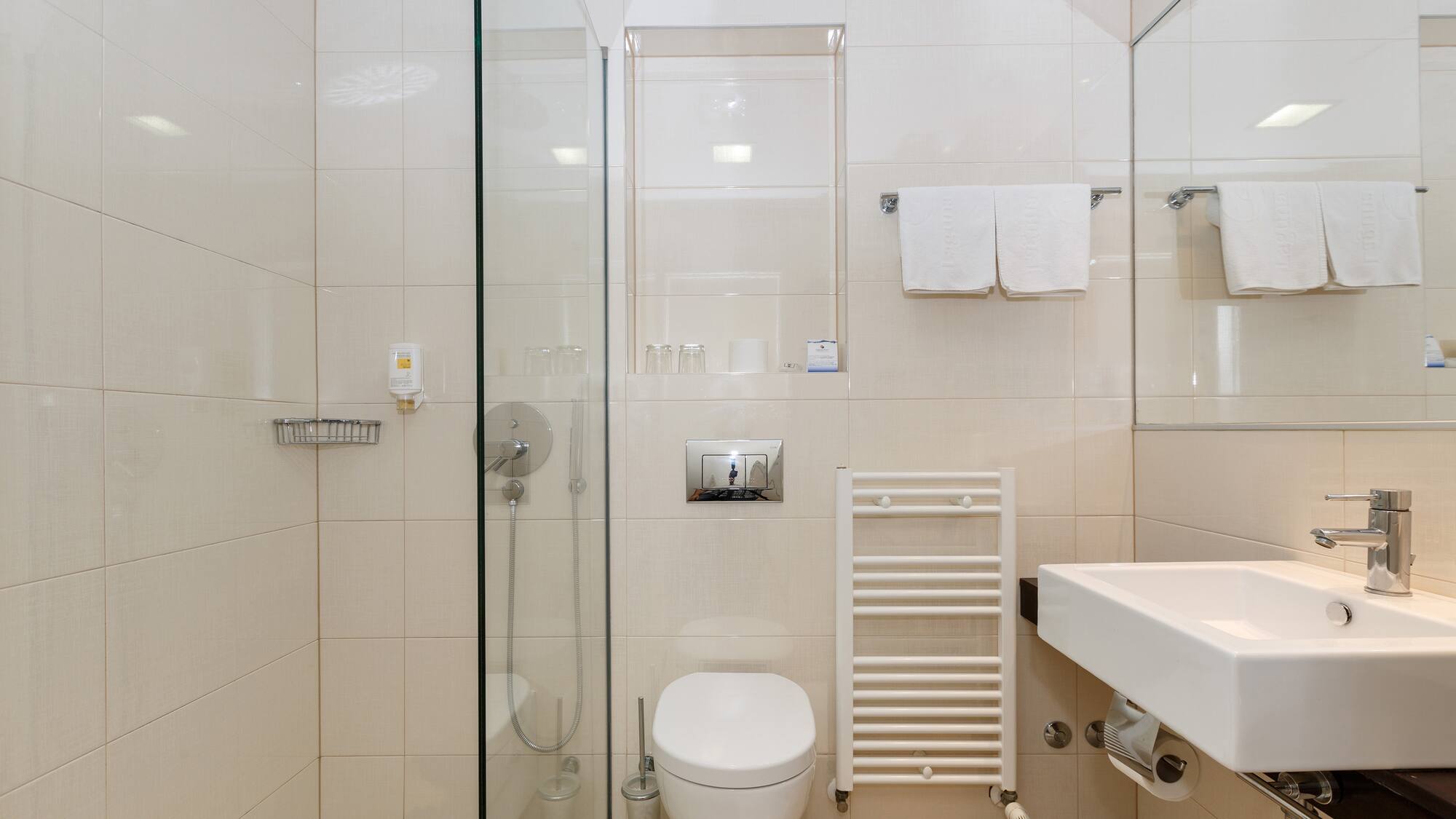 a bathroom with a glass shower door