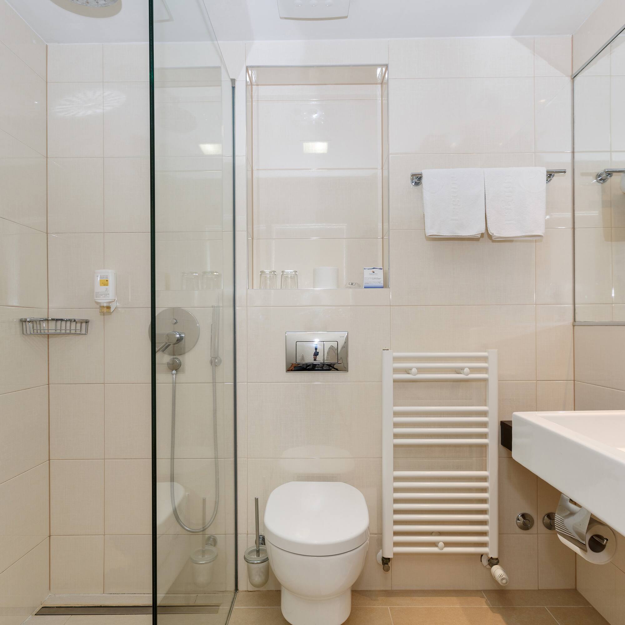 a bathroom with a glass shower door