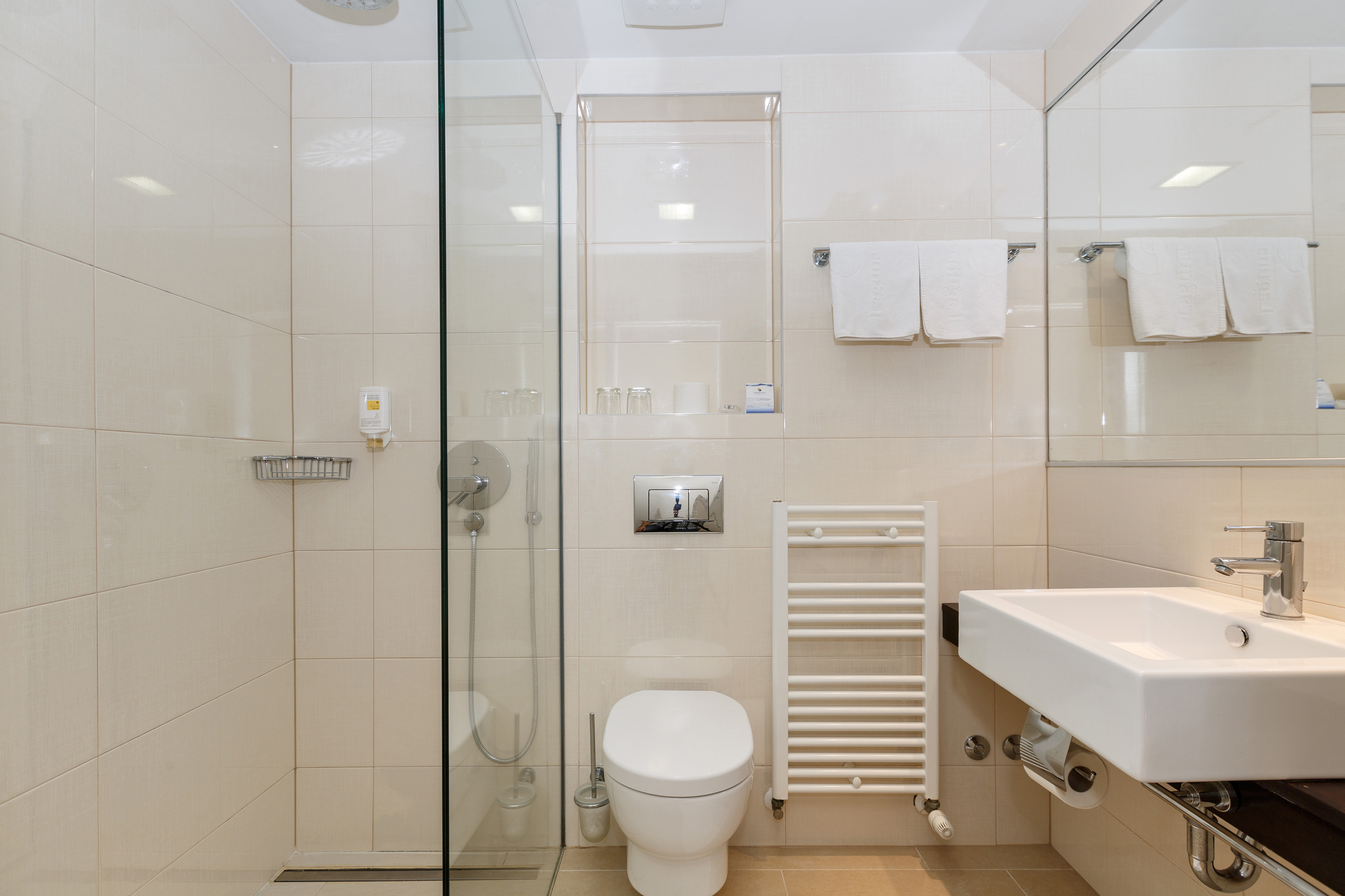 a bathroom with a glass shower door