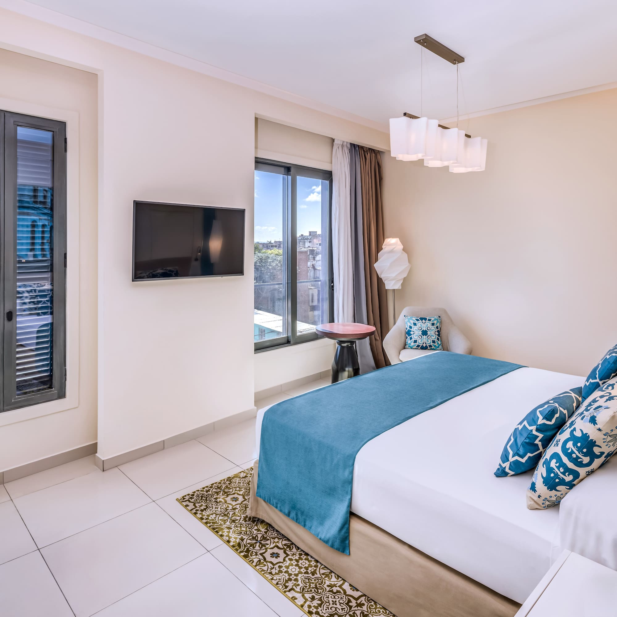 a bedroom with a bed and a television