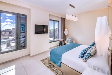 a bedroom with a bed and a television