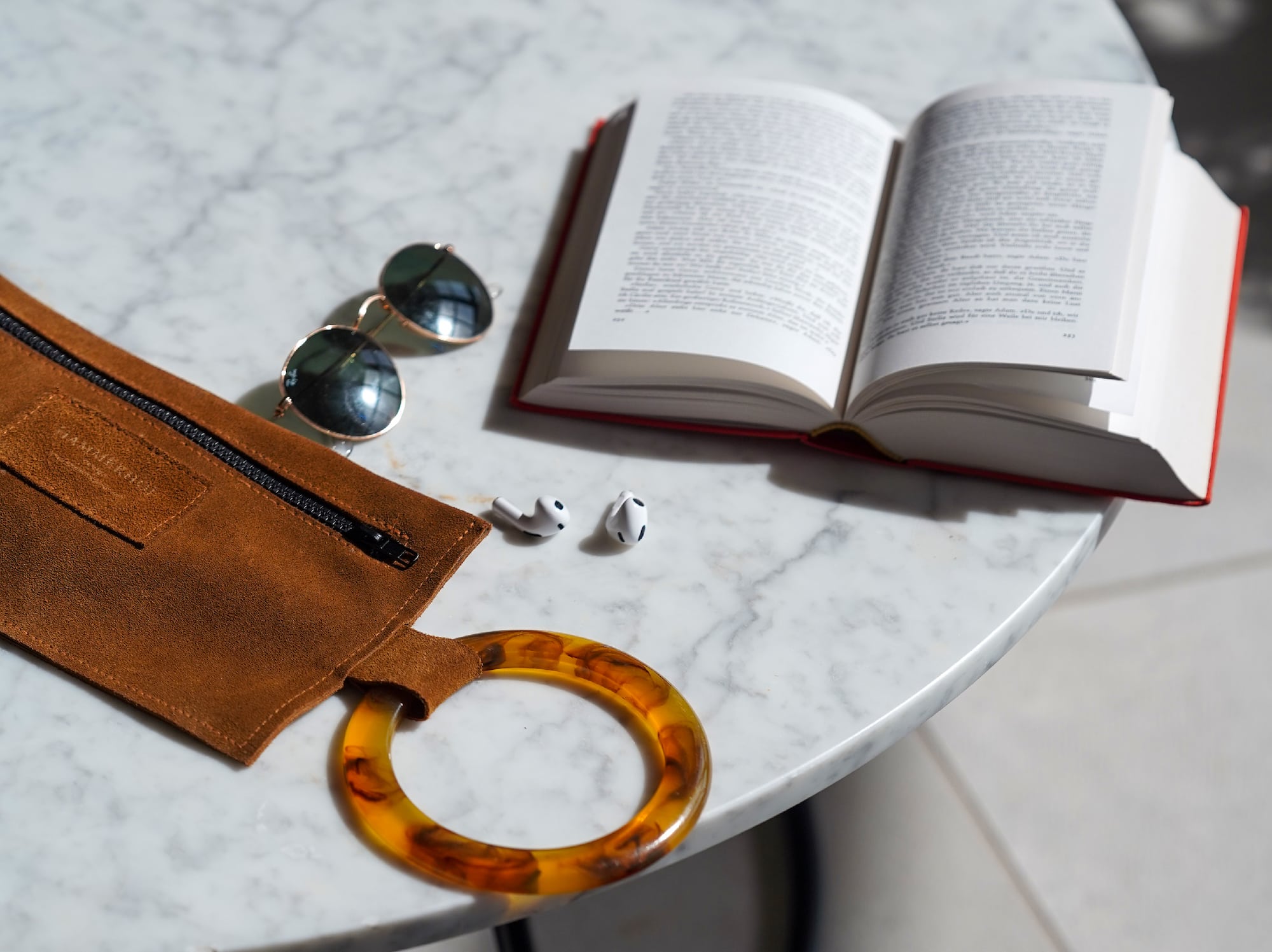 a book and sunglasses on a table