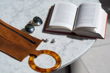 a book and sunglasses on a table