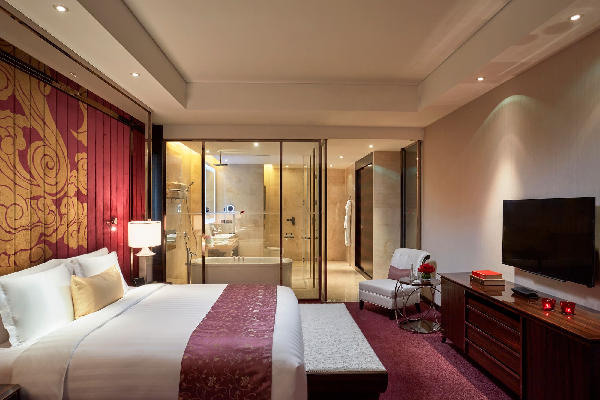 a bedroom with a glass door and a bed