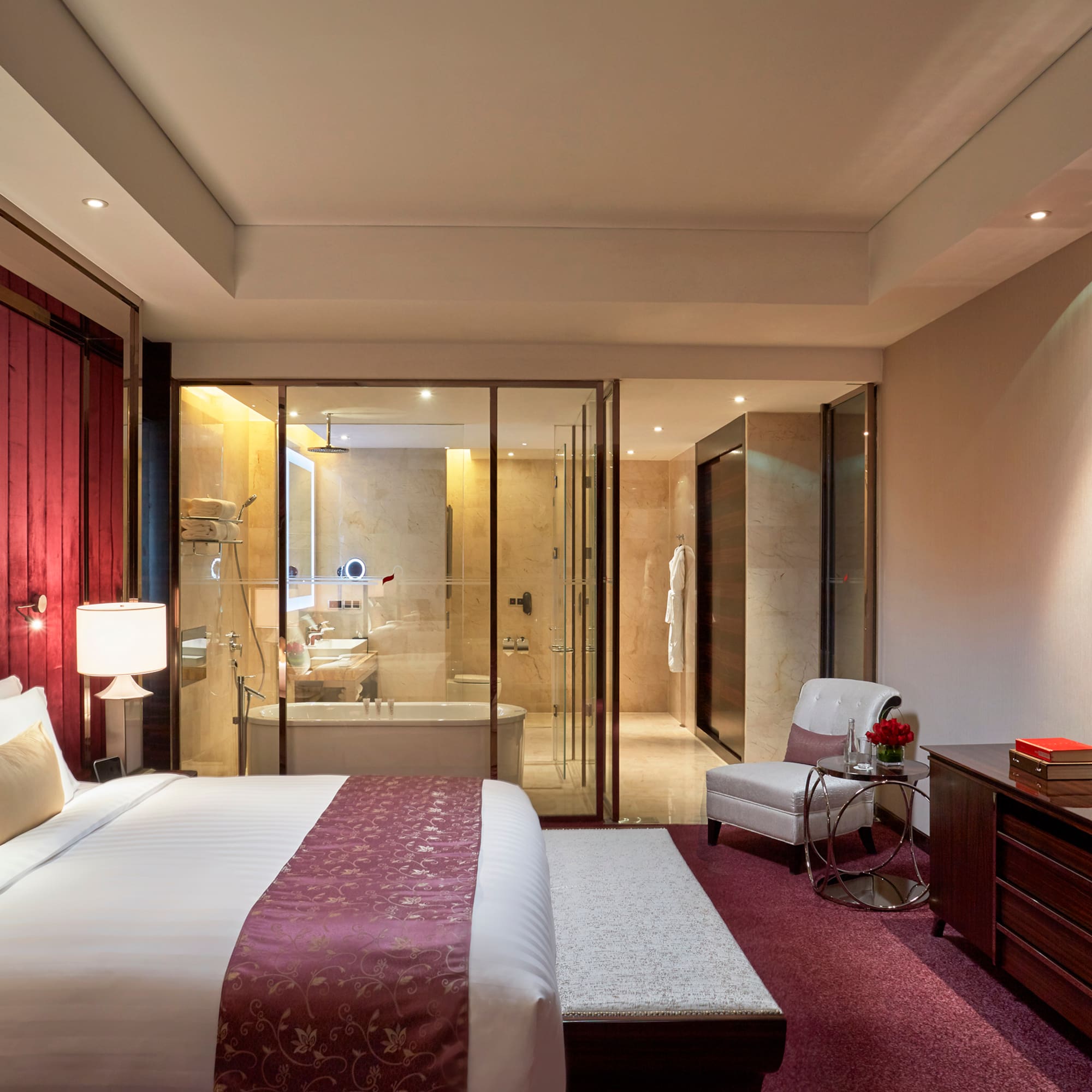 a bedroom with a glass door and a bed