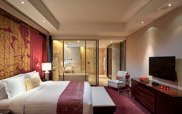 a bedroom with a glass door and a bed