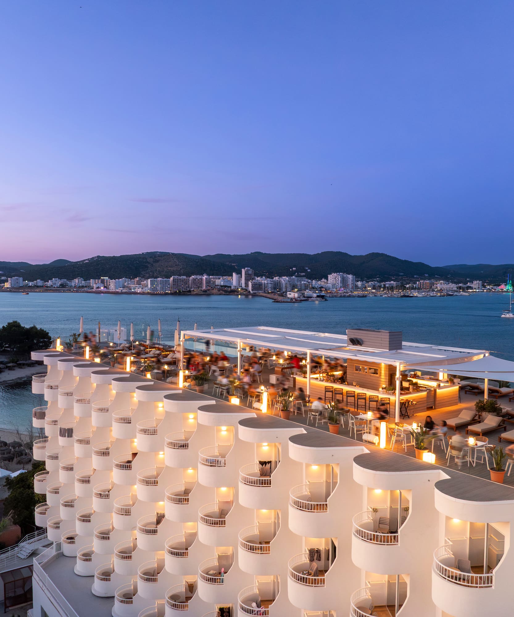 a building with many balconies and lights on top of it