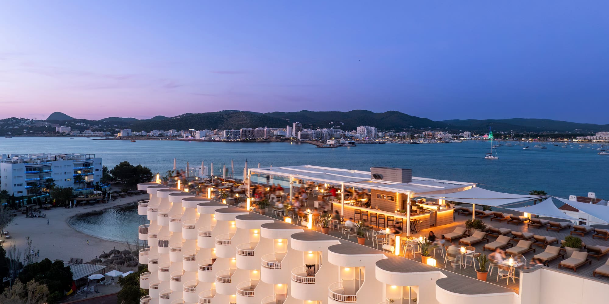 a building with many balconies and lights on top of it