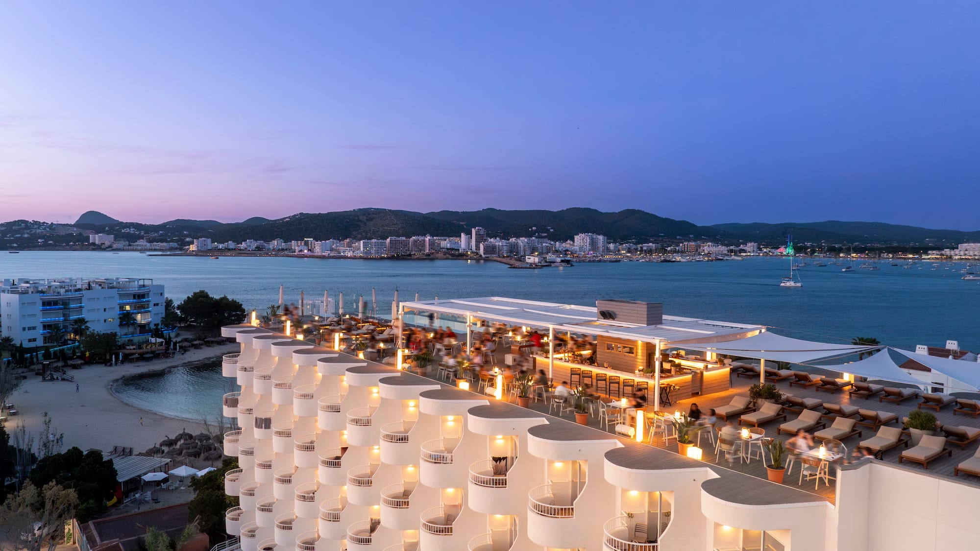 a building with many balconies and lights on top of it