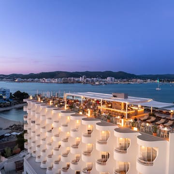 a building with many balconies and lights on top of it