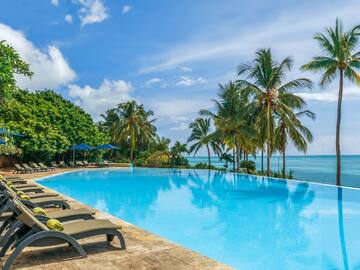 a pool with lounge chairs and palm trees