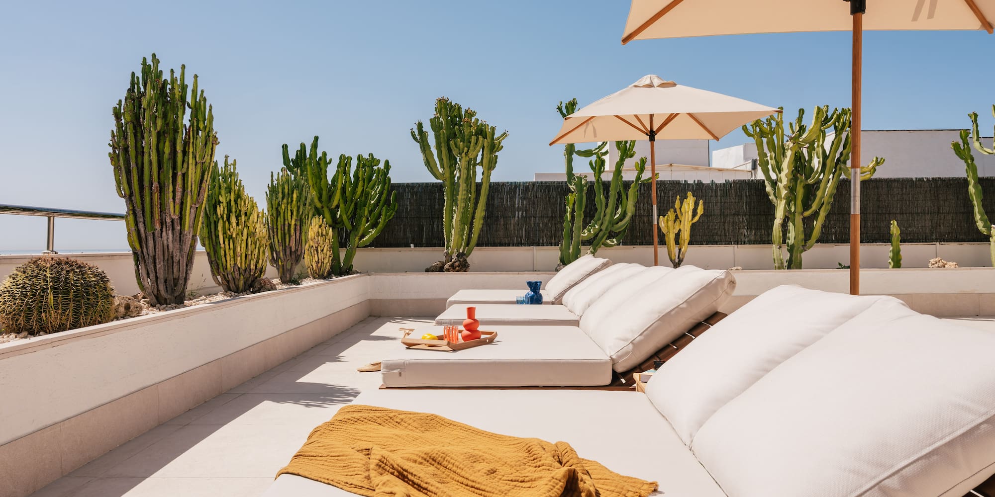 a lounge chairs and umbrellas on a patio