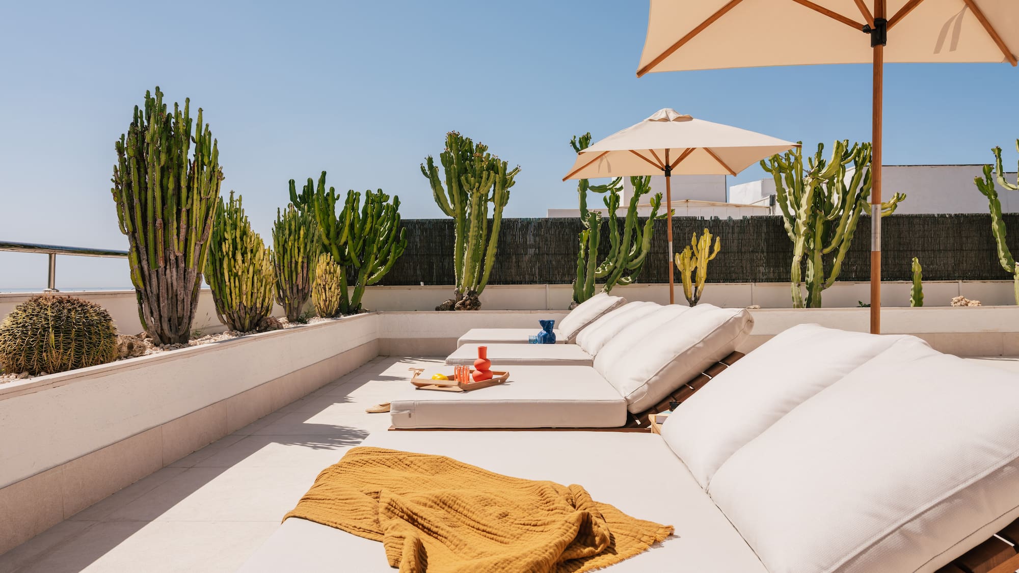 a lounge chairs and umbrellas on a patio
