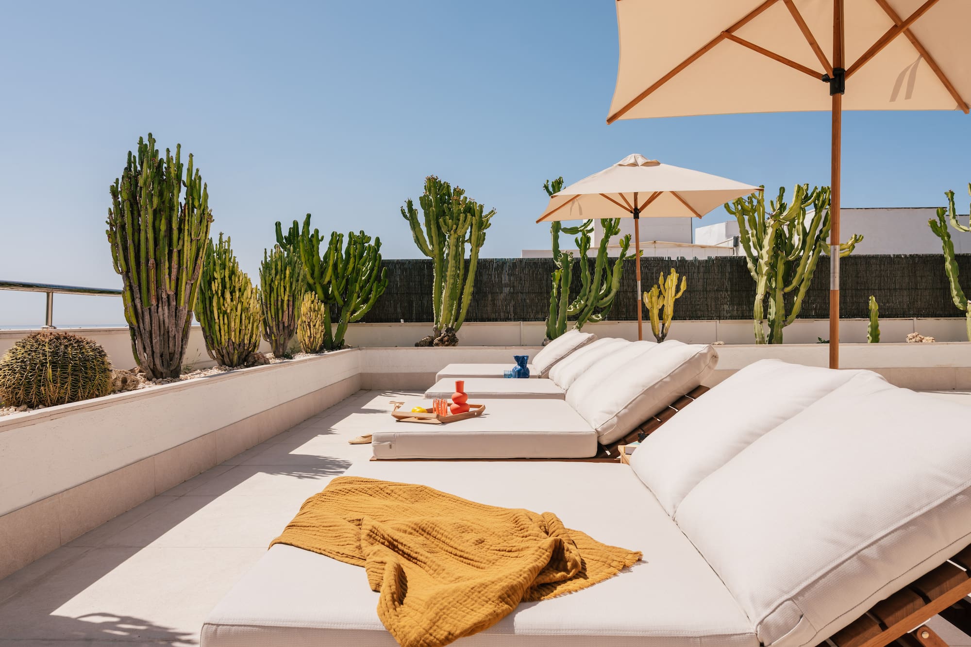 a lounge chairs and umbrellas on a patio