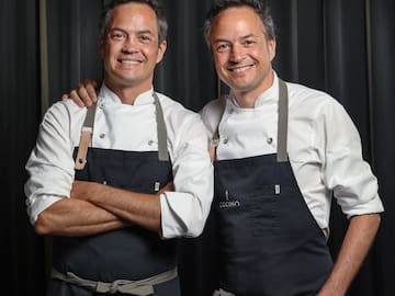 two men wearing black aprons