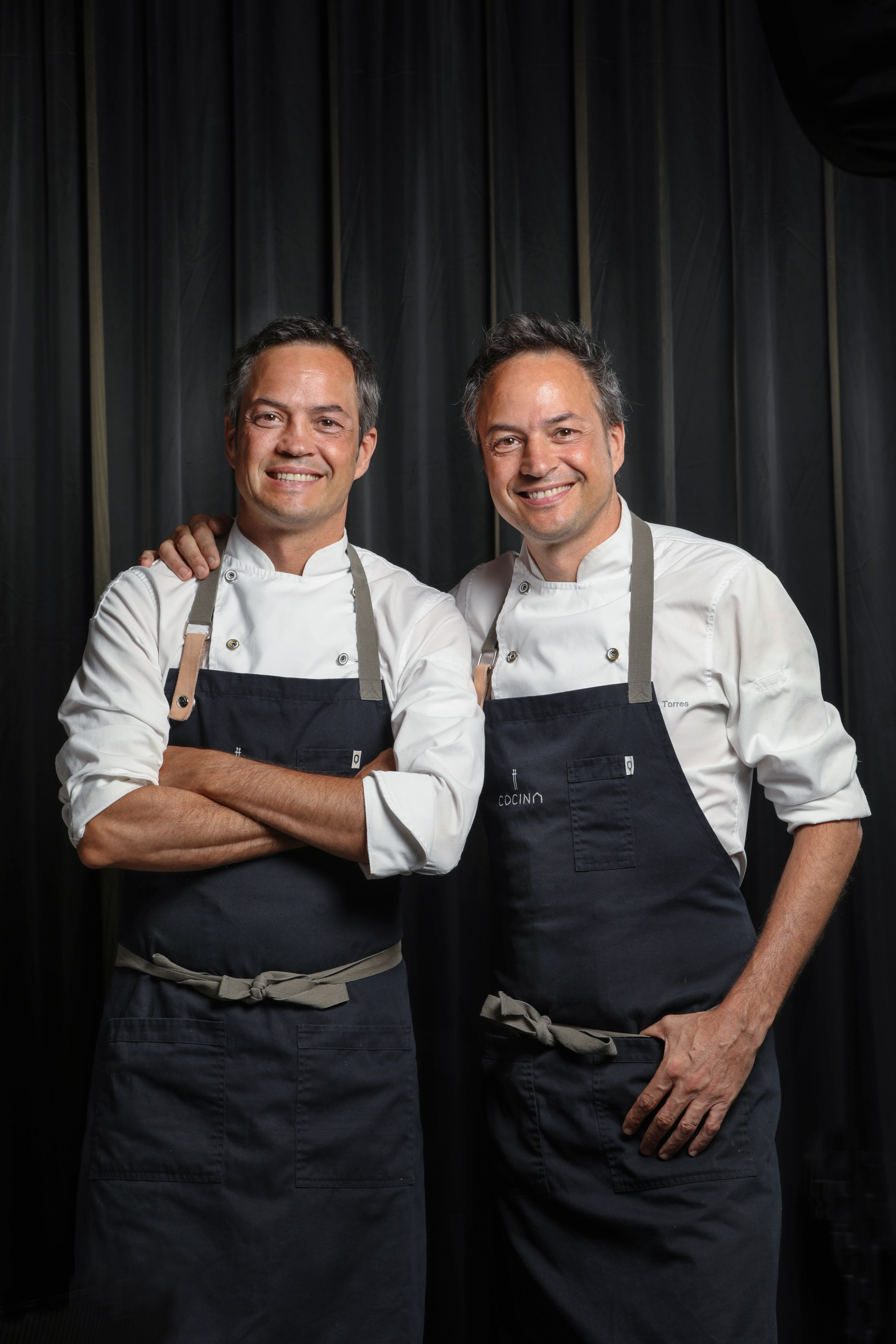 two men wearing black aprons