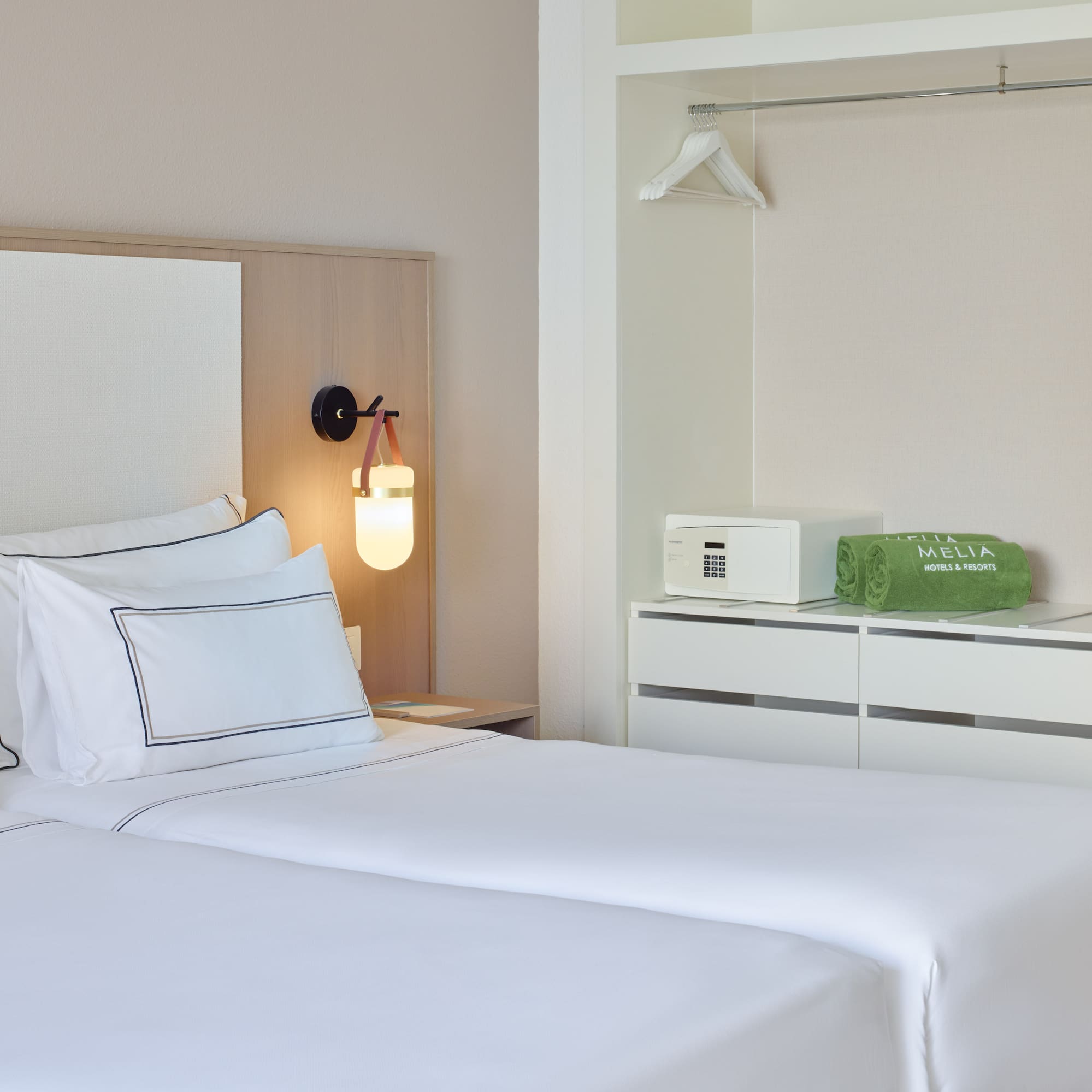 a room with two beds and a lamp