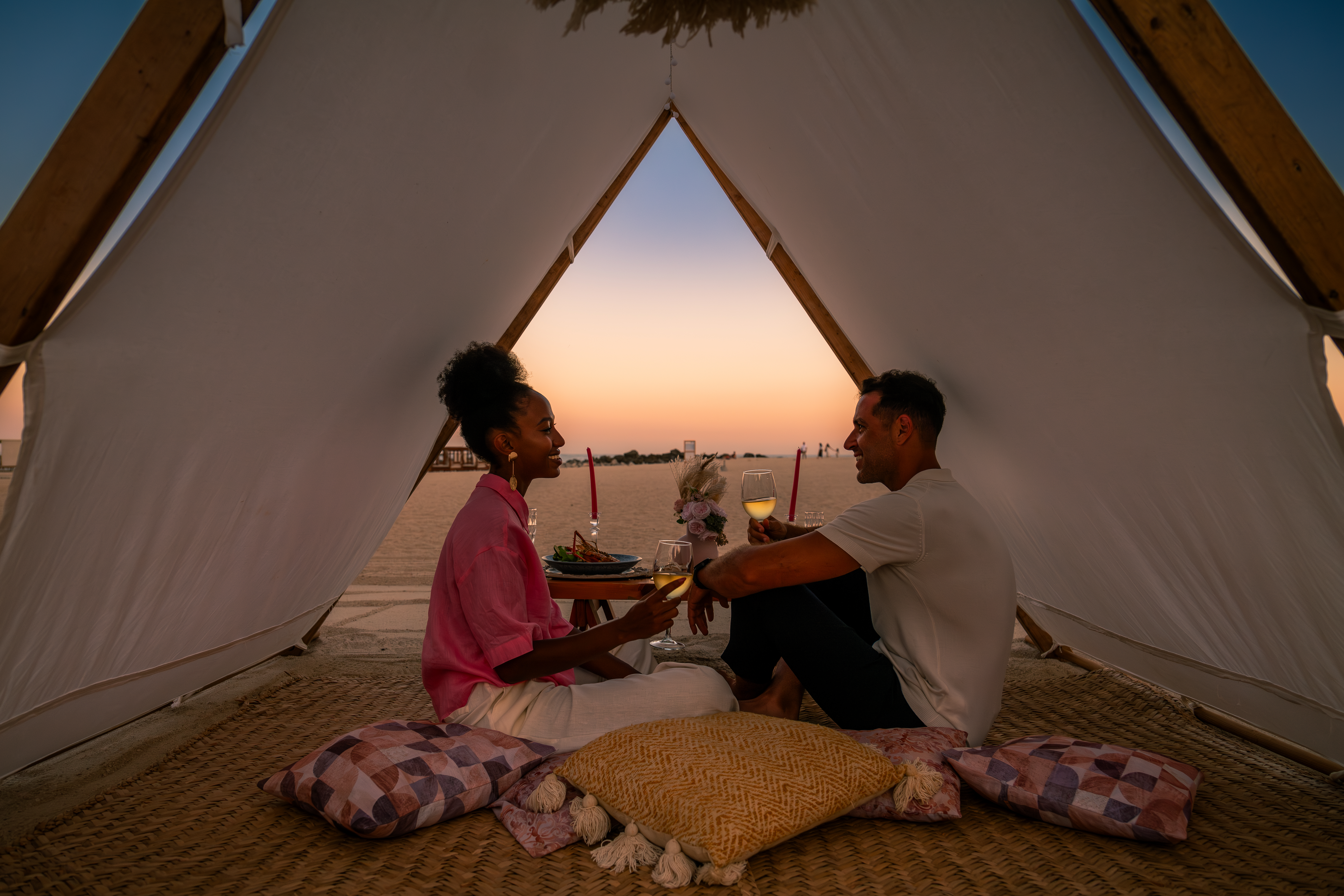 a man and woman sitting in a tent