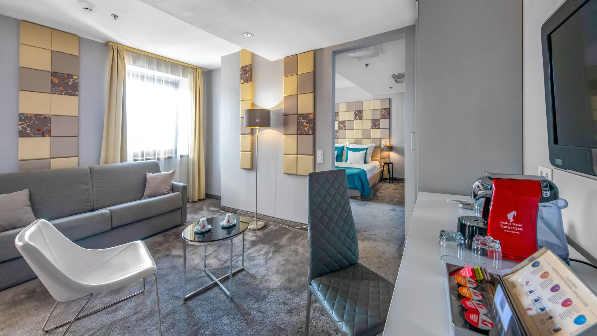 a room with a couch and a table and chairs