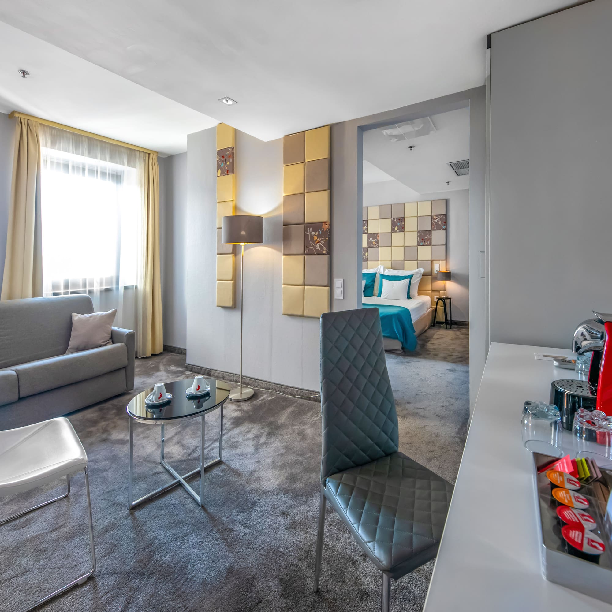 a room with a couch and a table and chairs