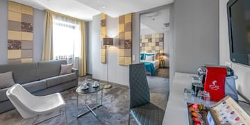 a room with a couch and a table and chairs