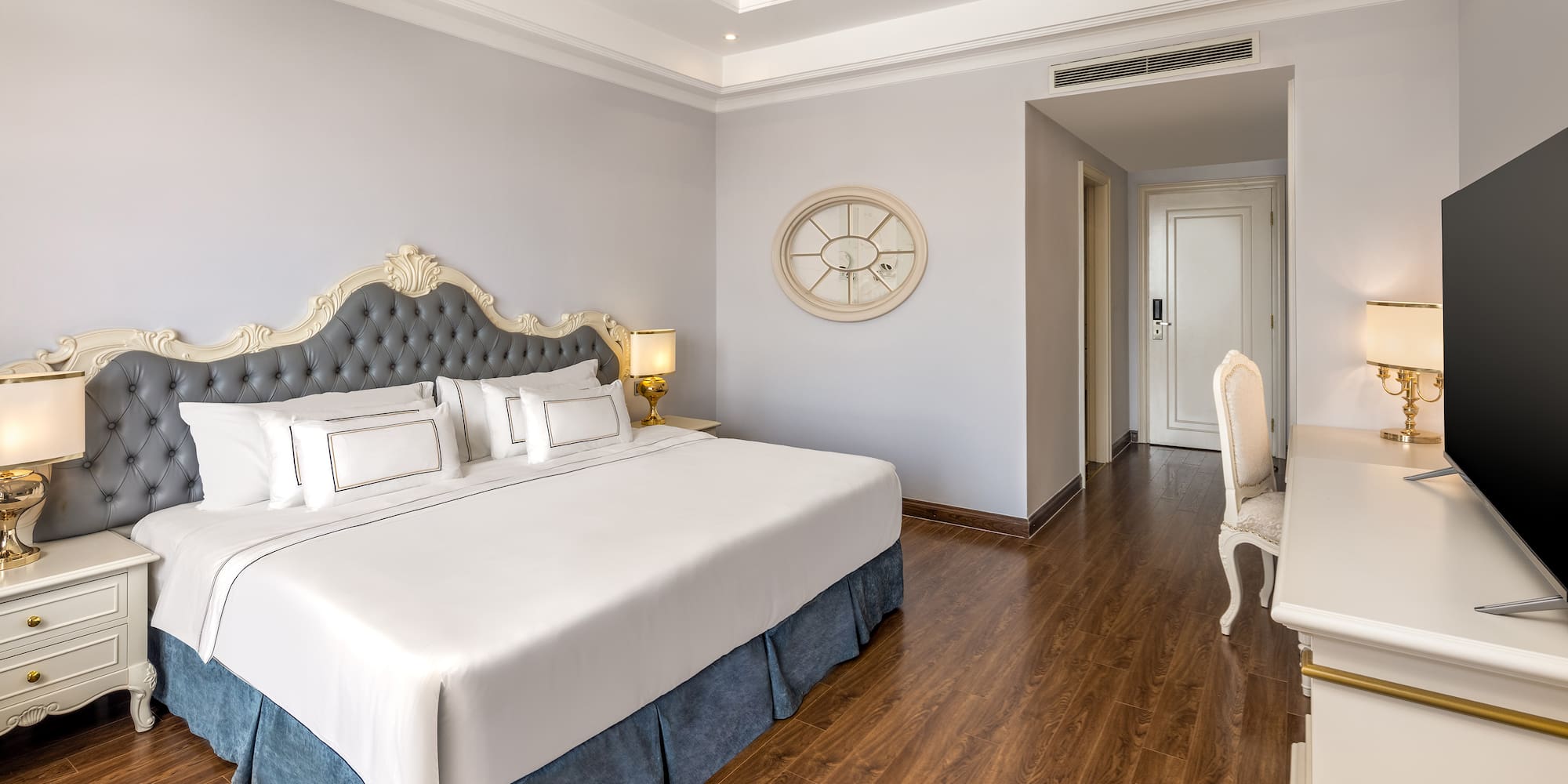 a bedroom with a white desk and a bed