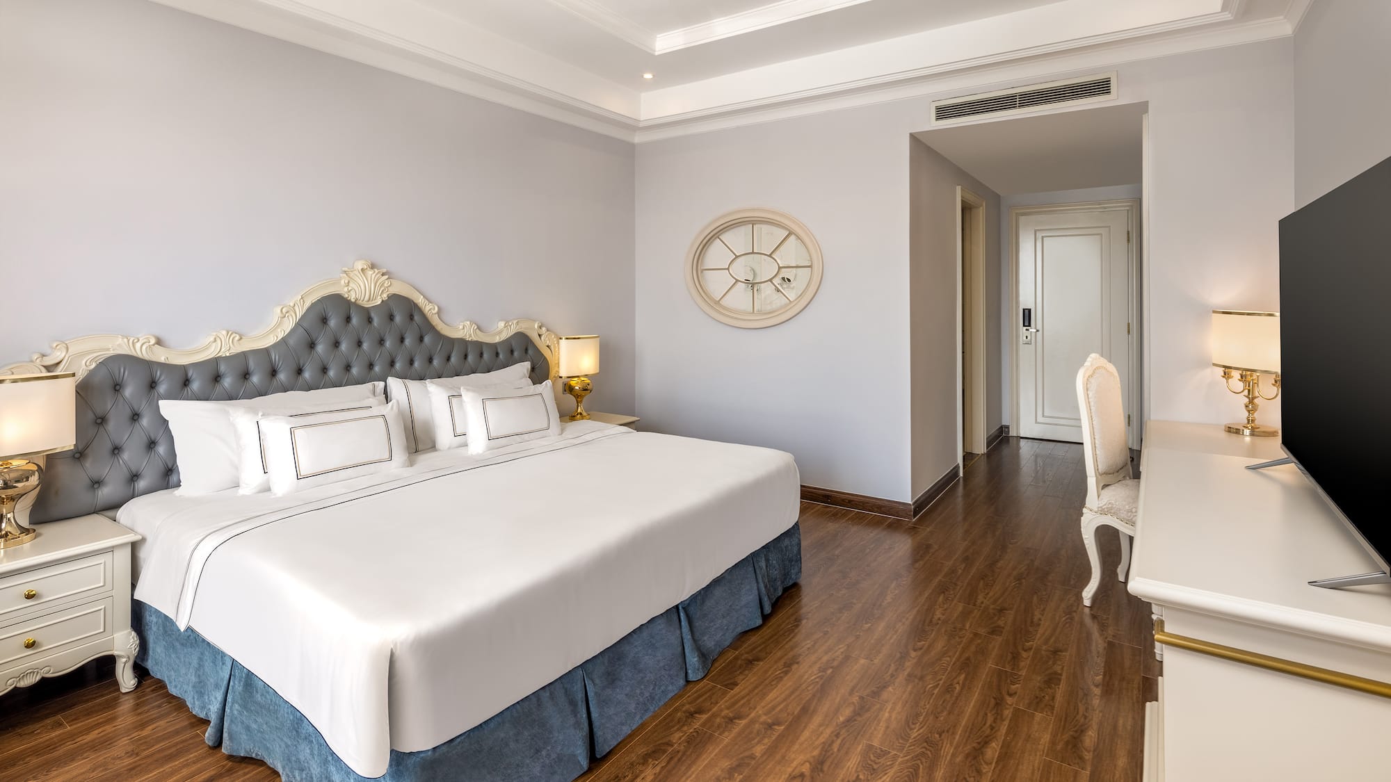 a bedroom with a white desk and a bed