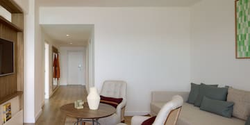 a living room with a couch and chairs