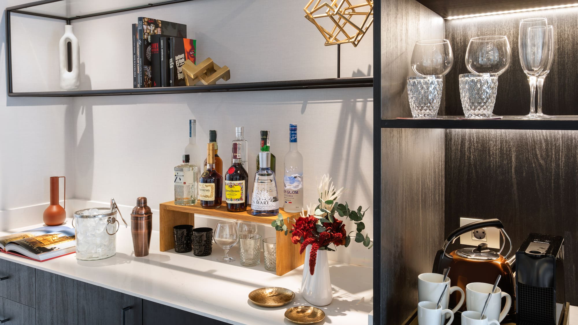a shelf with liquor bottles and glasses on it
